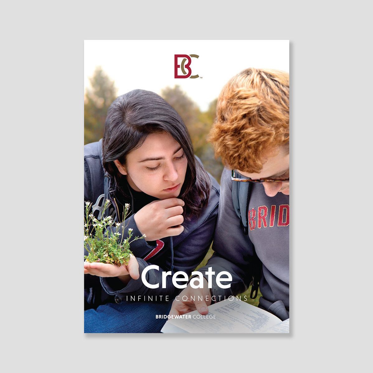 Brochure cover showing two students. Text: Create infinite connections.