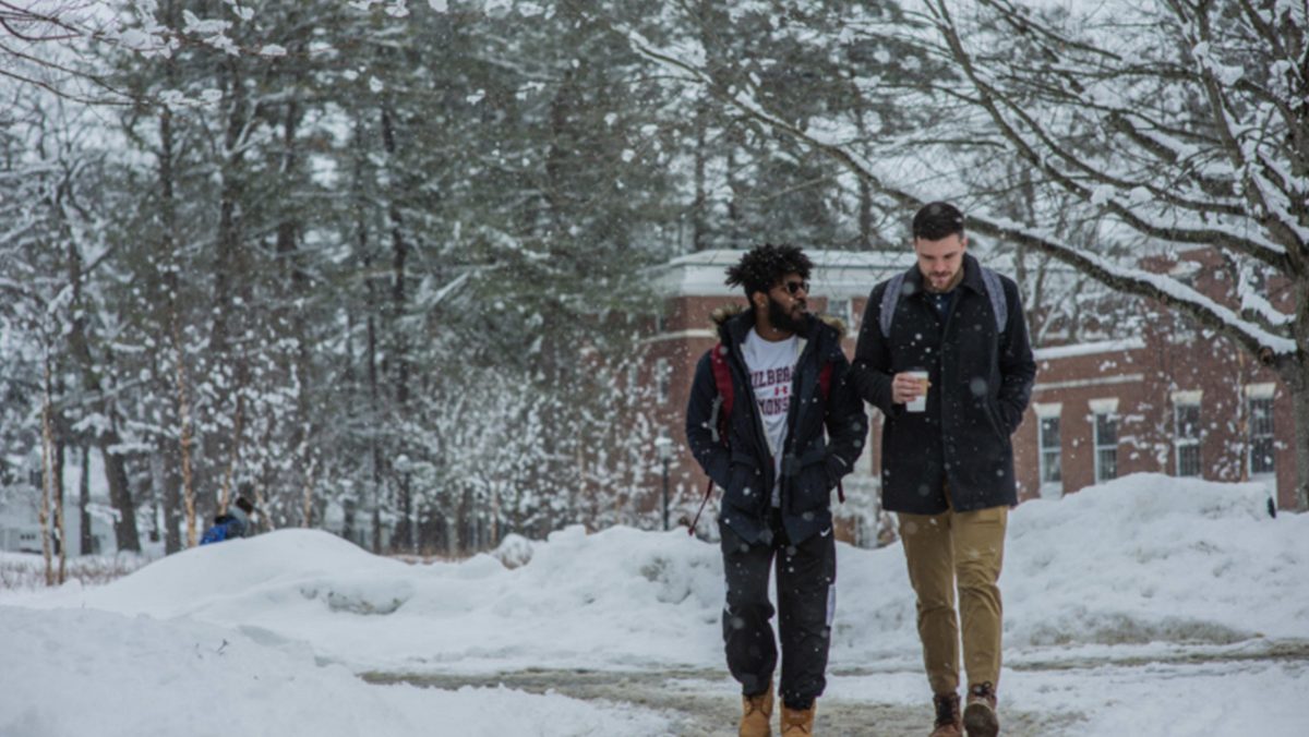 Two students walk in the snow.