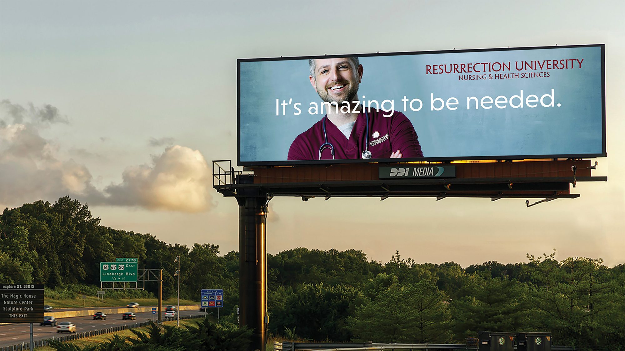 Billboard showing "It's amazing to be needed" creative; subject is a white man in red scrubs.